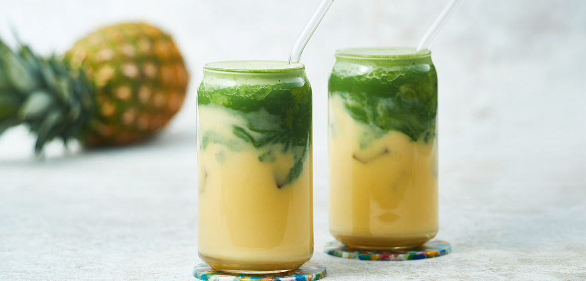 Iced pineapple and matcha beverage in a glass